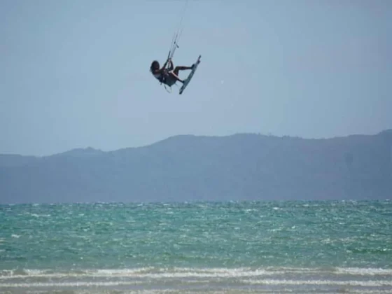 A kitesurfer jumping clear of the water