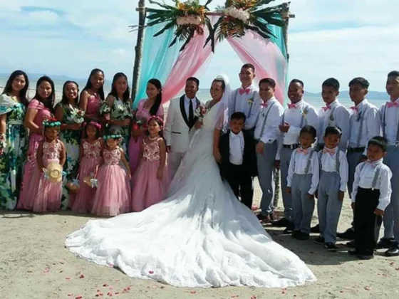A large wedding party posed together