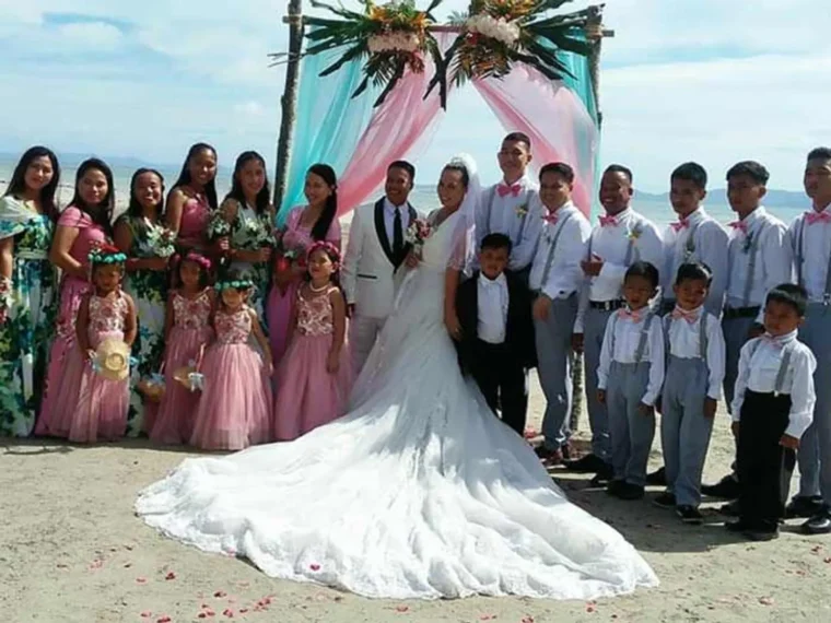 A large wedding party posed together at the resort
