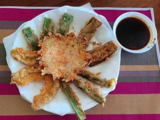 A dressed crab dish with dipping sauce