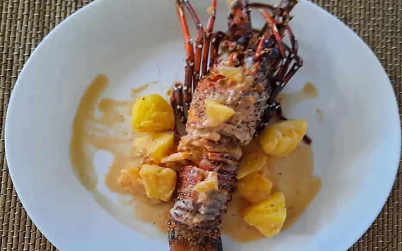 Grilled lobster plated with pineapple, photographed at the resort restobar