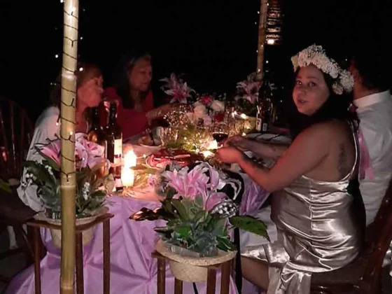Guests at a decorated long table in the evening
