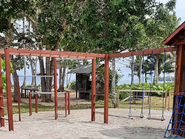 An open-sided timber structure beside the lawn