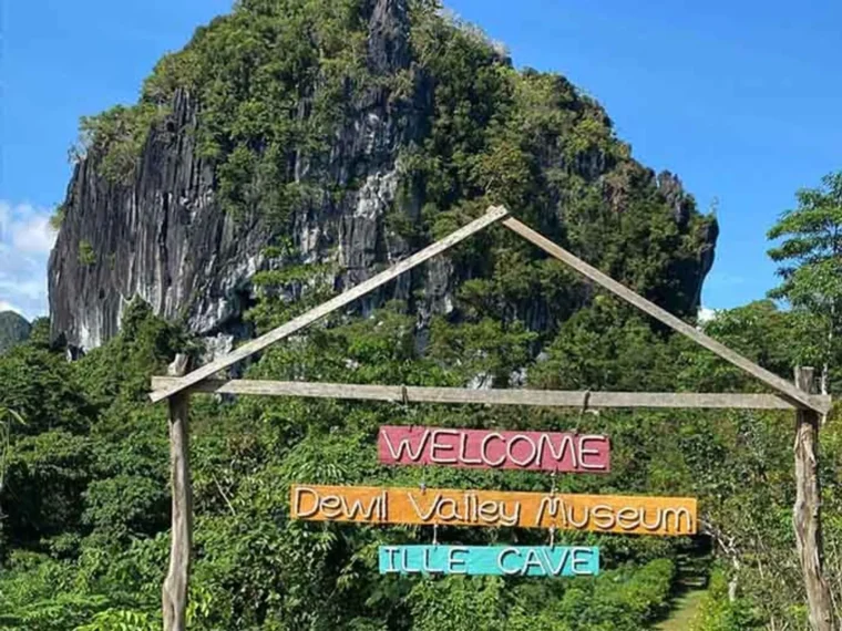 A welcome arch under limestone cliffs near the property